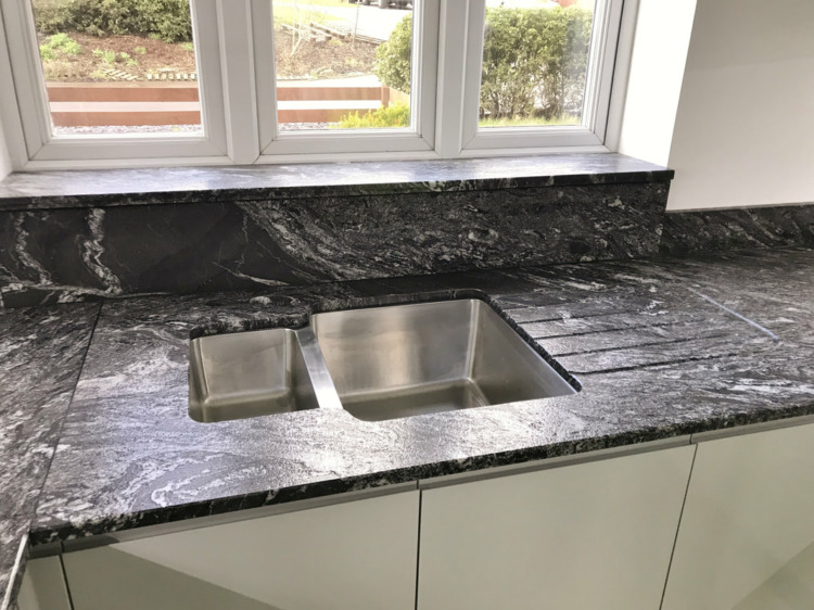 Dark Granite Worktop with White Base Cabinet