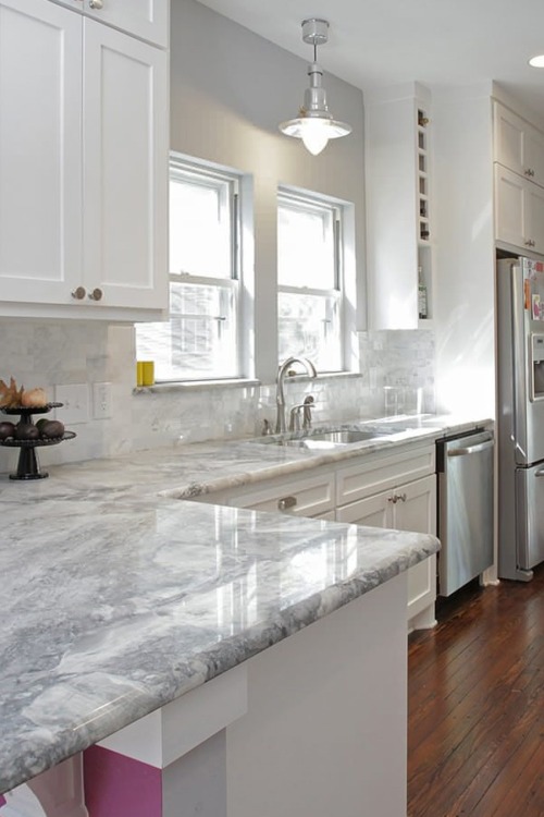 White quartzite countertops in traditional kitchen
