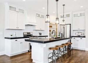 white island black countertops and brown stools